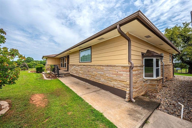 view of property exterior featuring a lawn