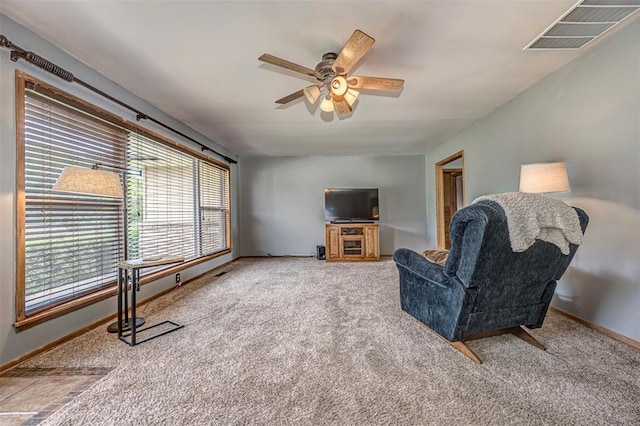 living room featuring ceiling fan, plenty of natural light, and carpet floors