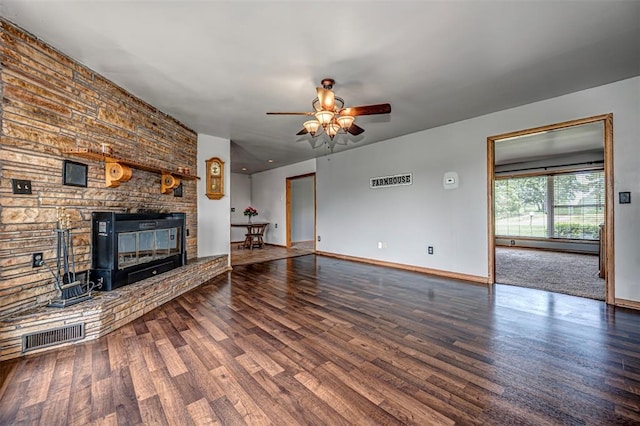 unfurnished living room with a large fireplace, ceiling fan, hardwood / wood-style floors, and baseboard heating