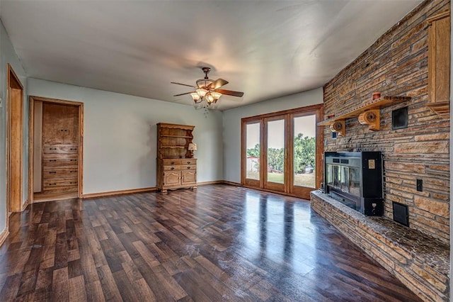 unfurnished living room featuring a fireplace, ceiling fan, and dark wood-type flooring