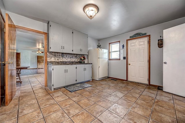 kitchen with white cabinetry, ceiling fan, light tile patterned floors, and white refrigerator