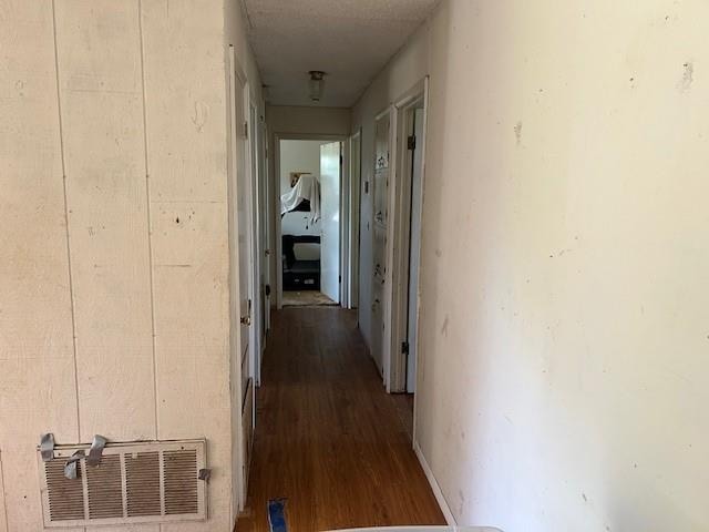 corridor featuring dark hardwood / wood-style flooring