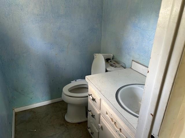 bathroom with tile patterned floors, vanity, and toilet