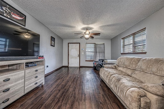 living room with dark hardwood / wood-style flooring and a textured ceiling