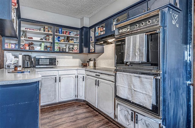 kitchen with blue cabinetry, a textured ceiling, dark hardwood / wood-style floors, and black appliances