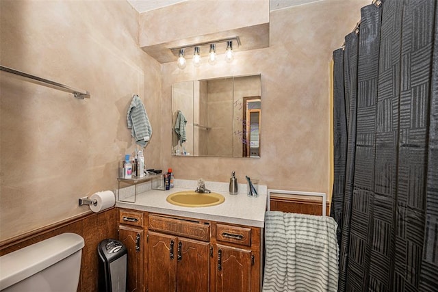 bathroom featuring vanity and toilet