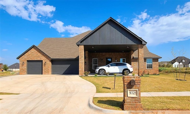 9304 SW 35th St, Oklahoma City, OK 73179 - view of front facade with brick siding, a front yard, an attached garage, concrete driveway, and board and batten siding