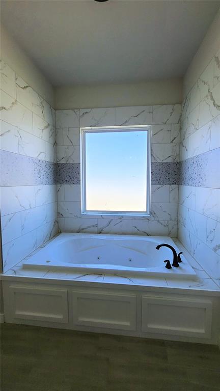 9304 SW 35th St, Oklahoma City, OK 73179 - bathroom with tile walls and a tub with jets
