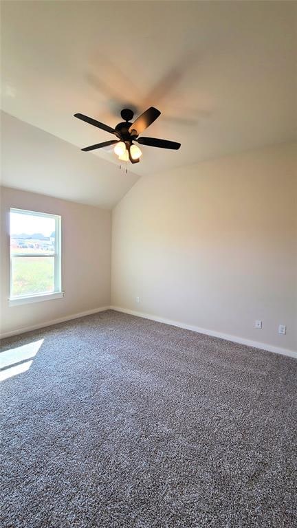 carpeted empty room with ceiling fan and lofted ceiling