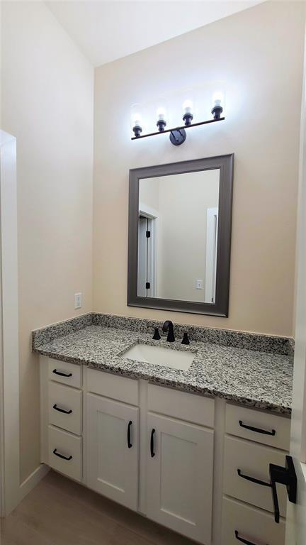 9304 SW 35th St, Oklahoma City, OK 73179 - bathroom featuring vanity and wood finished floors