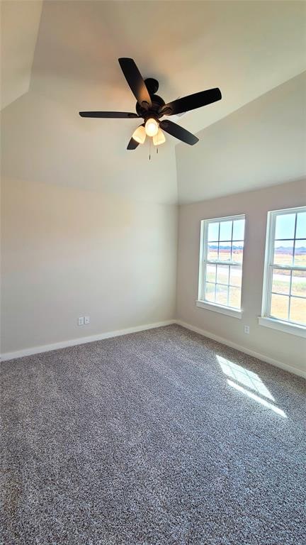 unfurnished room with carpet flooring, ceiling fan, and vaulted ceiling