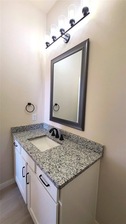 bathroom featuring vanity and wood-type flooring