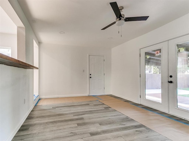 interior space with french doors, light wood-type flooring, and ceiling fan