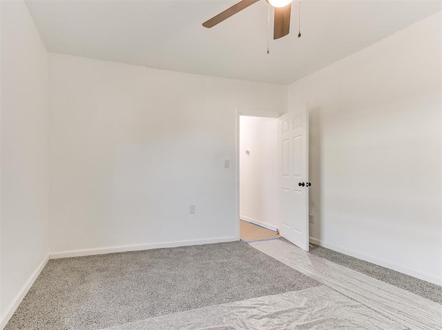 unfurnished room with ceiling fan and light carpet