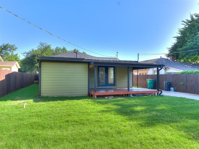 rear view of house with a yard, central air condition unit, and a wooden deck