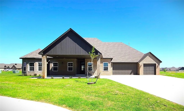 view of front of home featuring a front yard, a porch, and a garage