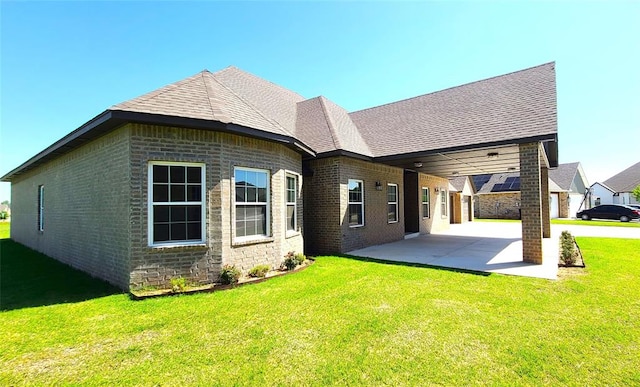 back of house with a patio area and a yard