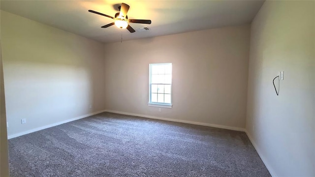 unfurnished room featuring ceiling fan and dark carpet