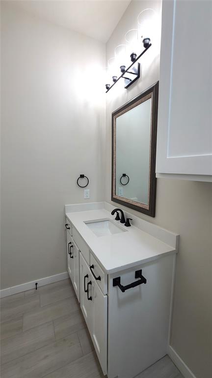 bathroom featuring hardwood / wood-style floors and vanity