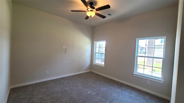 unfurnished room featuring carpet flooring, ceiling fan, and a wealth of natural light