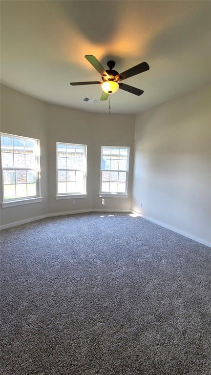 109 Tralee Ct, Yukon, OK 73099 - empty room featuring baseboards, carpet flooring, and a ceiling fan