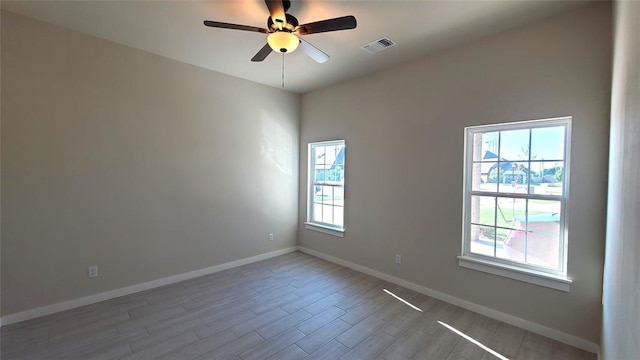 empty room featuring ceiling fan and light hardwood / wood-style floors