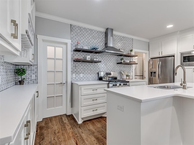 kitchen with appliances with stainless steel finishes, backsplash, crown molding, dark wood-type flooring, and wall chimney range hood