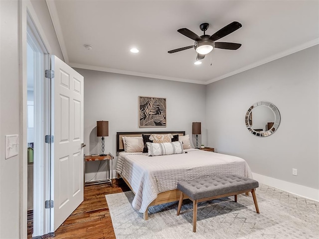 bedroom featuring dark hardwood / wood-style floors, ceiling fan, and crown molding