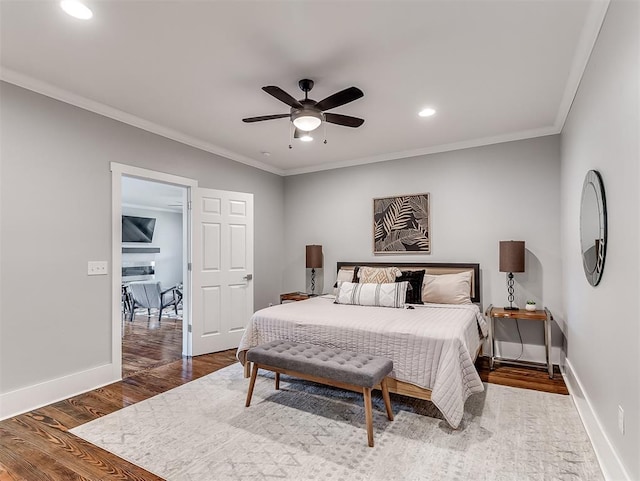 bedroom featuring ceiling fan, crown molding, and dark wood-type flooring