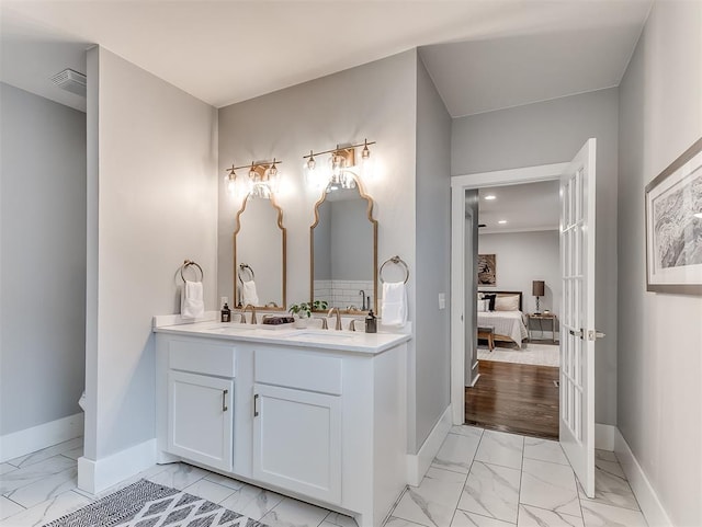 bathroom with french doors, vanity, and hardwood / wood-style flooring