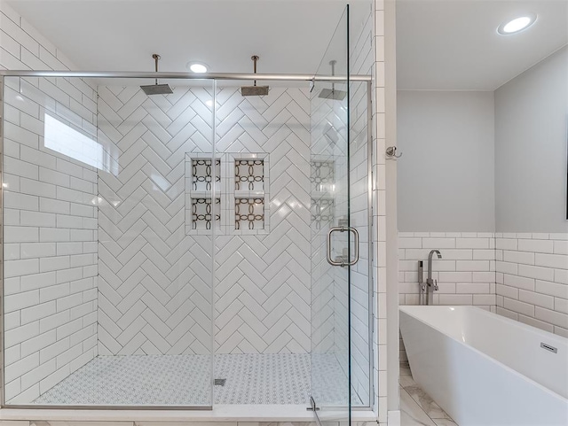 bathroom with separate shower and tub and tile walls