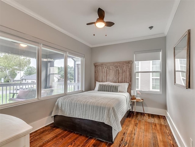 bedroom with multiple windows, ceiling fan, ornamental molding, and hardwood / wood-style flooring