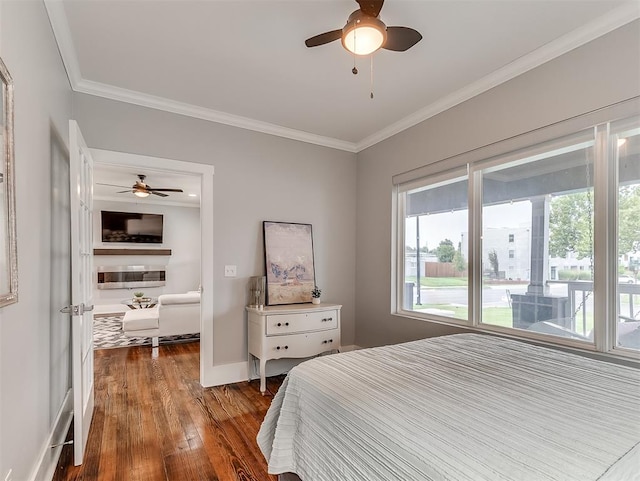 bedroom featuring multiple windows, ceiling fan, crown molding, and wood-type flooring