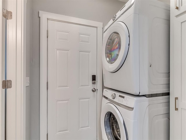 washroom featuring stacked washer / dryer