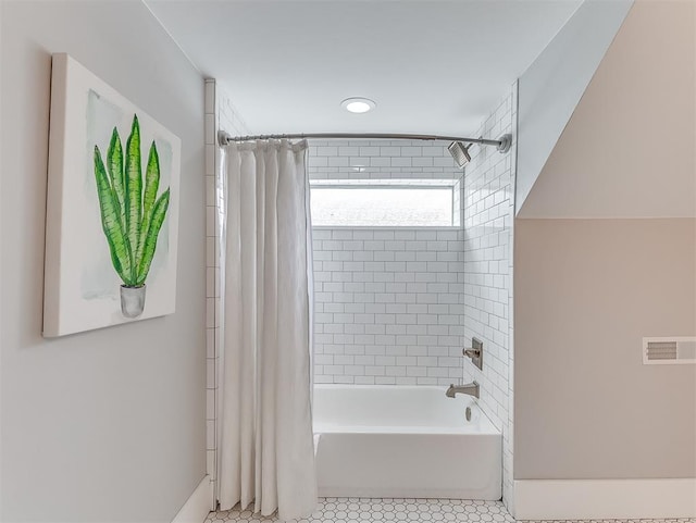 bathroom with tile patterned flooring and shower / bath combination with curtain