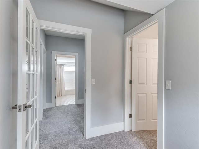 hall featuring french doors and carpet floors