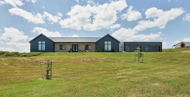 view of front of house with a front yard and an outdoor structure