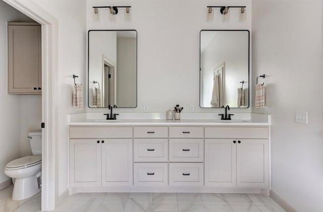 bathroom with vanity and toilet