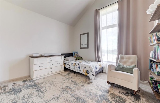 carpeted bedroom with lofted ceiling