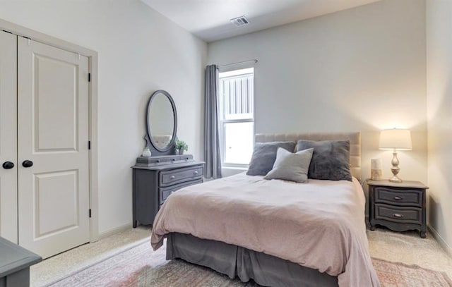 carpeted bedroom with a closet