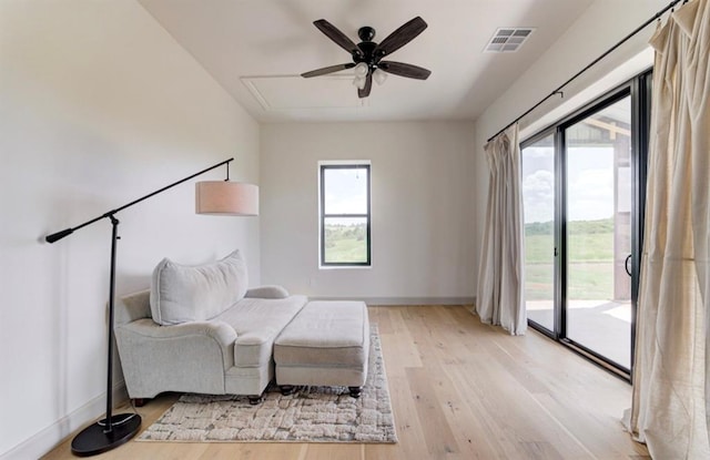 sitting room featuring ceiling fan and light hardwood / wood-style floors