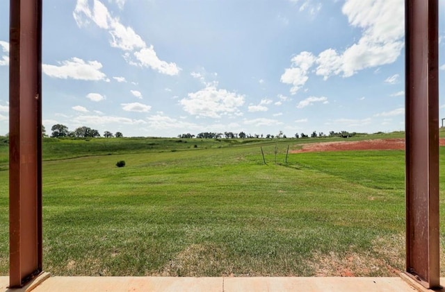 view of yard with a rural view