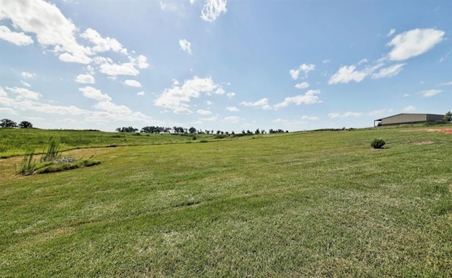 view of yard with a rural view