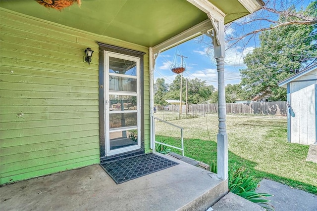 view of exterior entry with a lawn