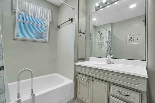 bathroom with a paneled ceiling, vanity, and shower / bath combination with curtain