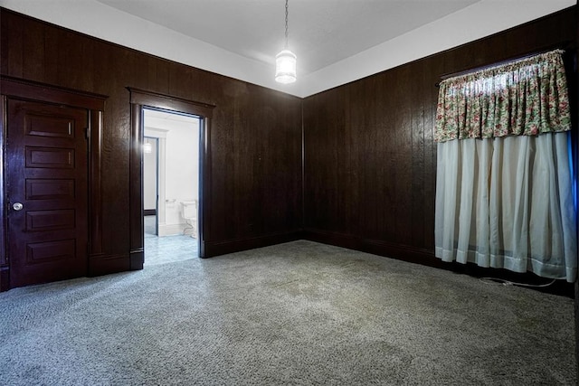 unfurnished room with wooden walls