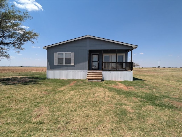 manufactured / mobile home featuring a rural view and a front lawn