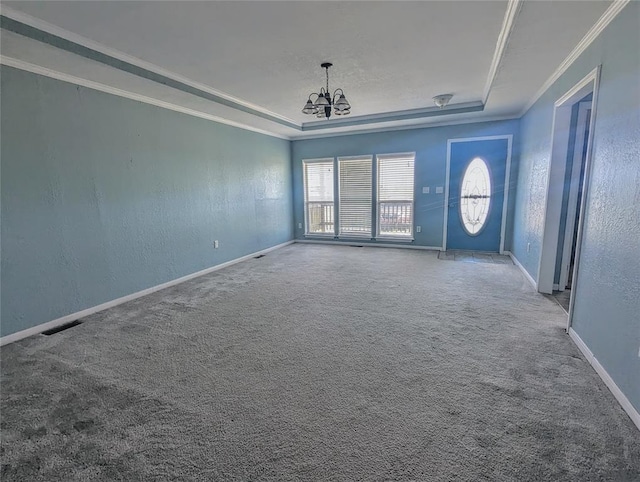 interior space with a chandelier, carpet floors, and crown molding