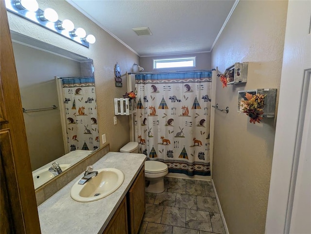 bathroom with crown molding, vanity, a textured ceiling, and toilet