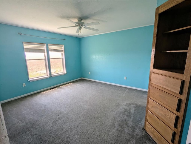 carpeted empty room featuring ceiling fan